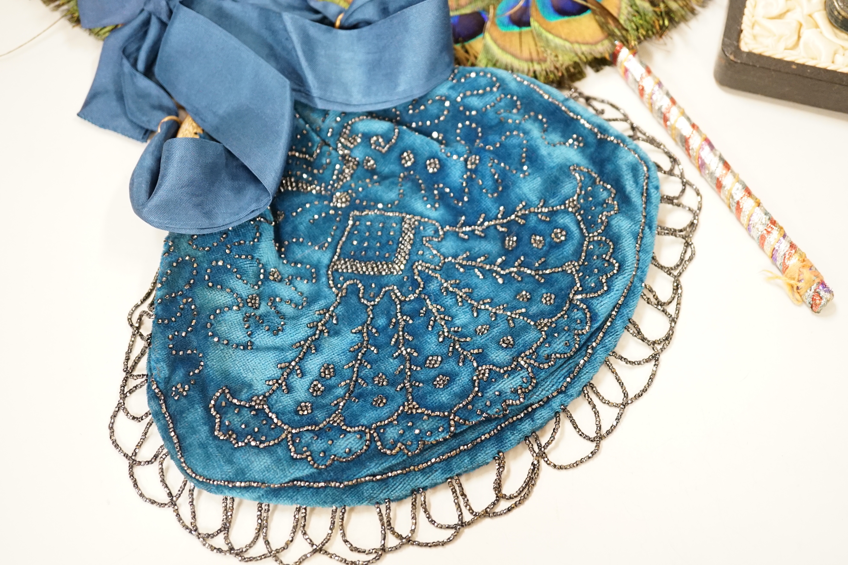 A 19th century peacock feather fan, a cut steel bag and a cased leather and silver mounted purse and card case, fan 41cm high